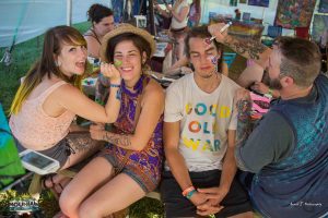 mountain music festival 2017 attendees painting faces inside the visual artist tent at ace adventure resort