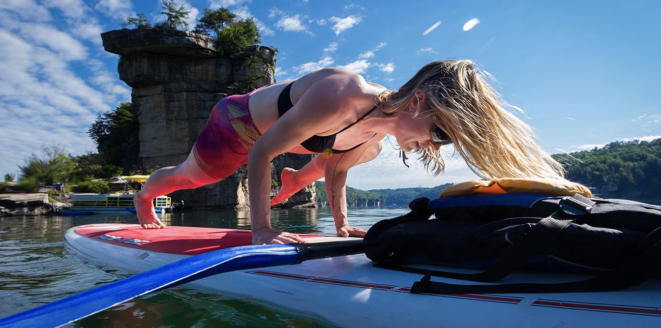 Floating, swimming, and yoga on SUP boards as part of the multisport pontoon adventure on Summersville Lake with ACE Adventure Resort.