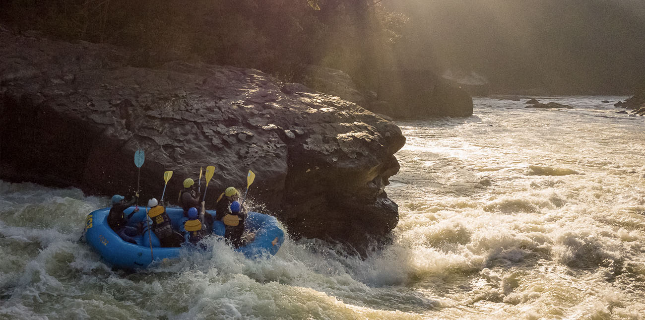 Smacking paddles on Pillow Rock Class V rapid on the Upper Gauley River with ACE Adventure Resort.