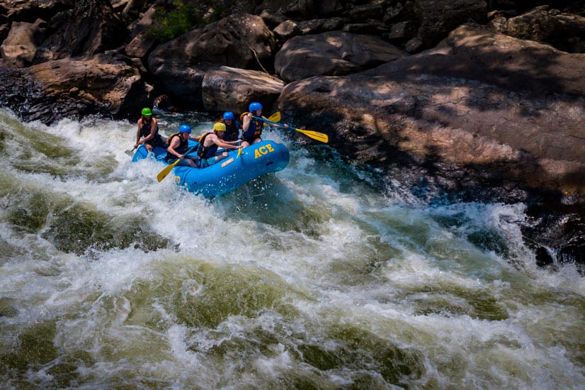 New River Gorge rafting guests paddling through Lower Keeney Rapid with ACE Adventure Resort.