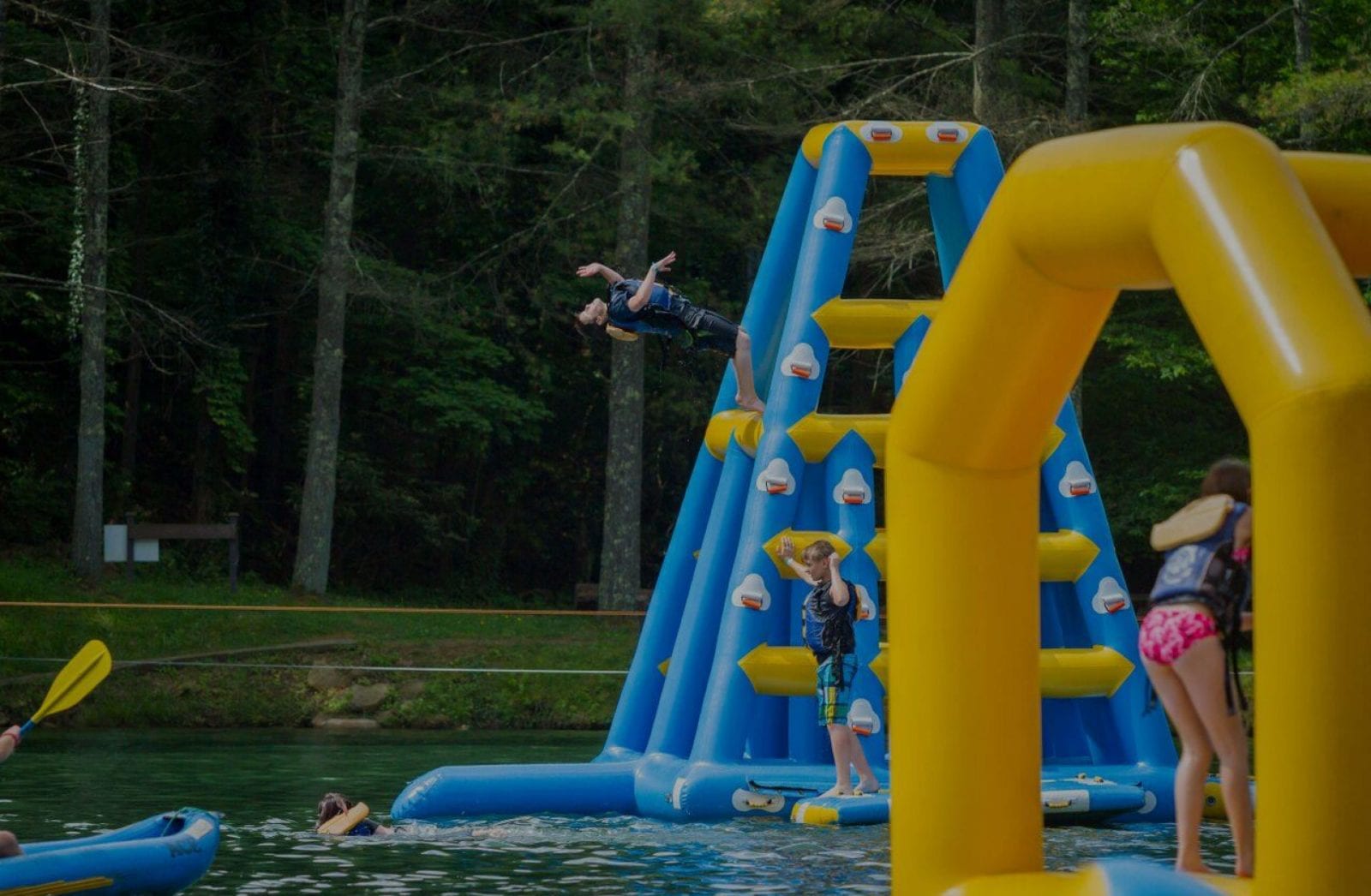 A young man leaps from an inflatable tower into the lake in ACE's Water Park in West Virginia.
