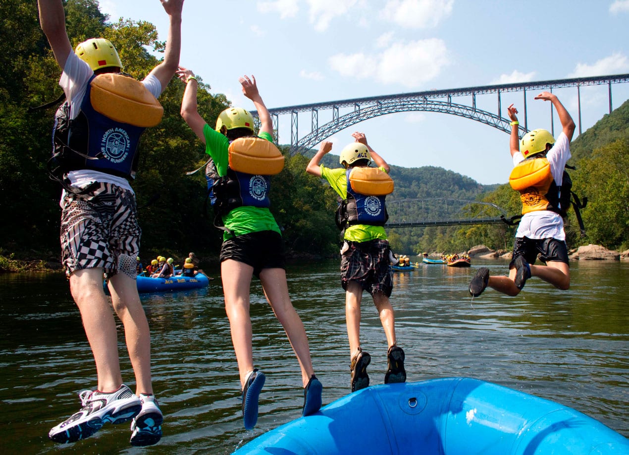 a youth group adventures by jumping from their raft into the river