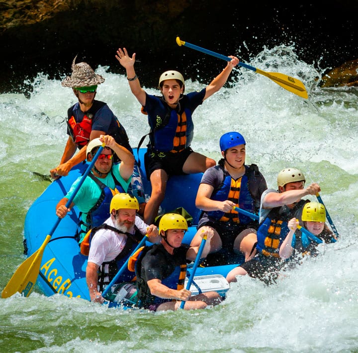 A closeup of smiling friends on a new river gorge rafting trip.