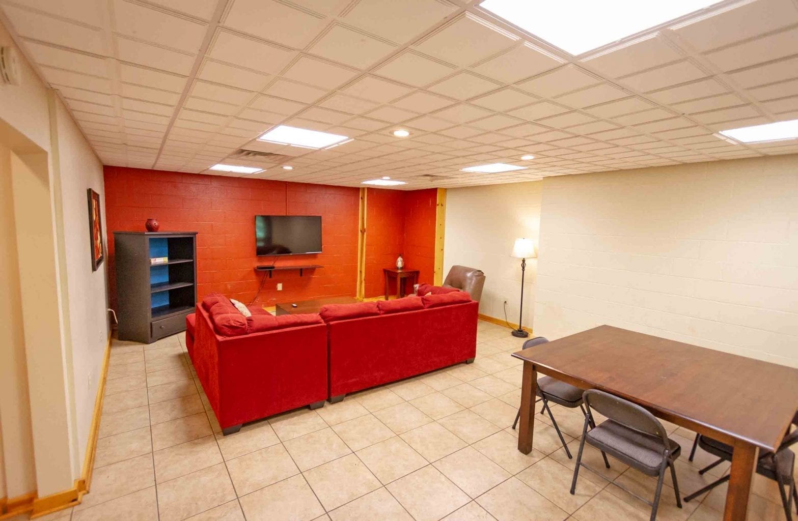 A view of the common area and dining table in the basement of Red Fox Log Home at ACE Adventure Resort.