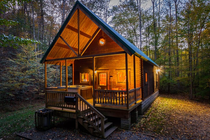 An illuminated night view of the Aspen Log home one of ACE's new river gorge vacation home rentals