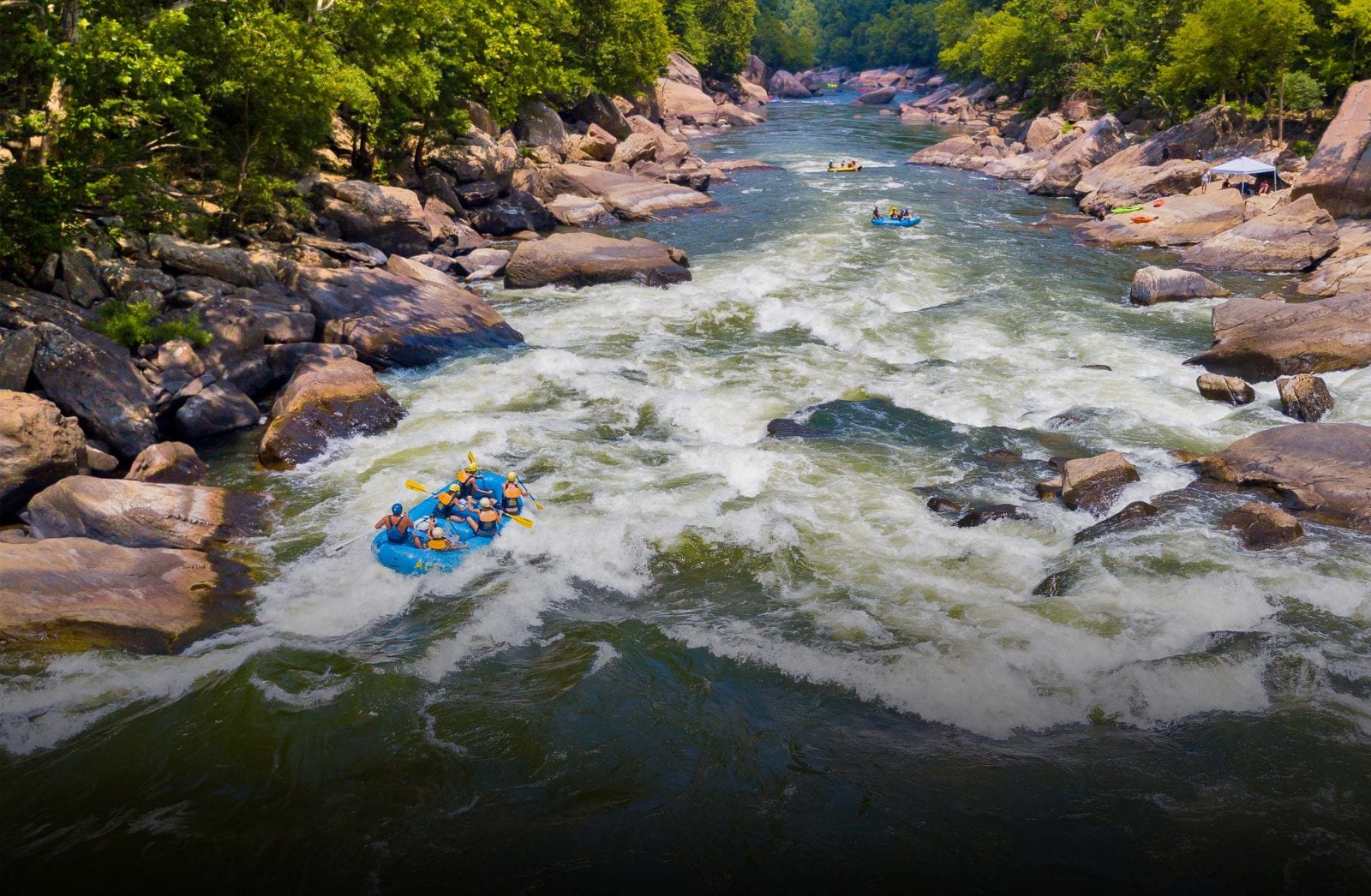 White water rafting guest challenge Lower Keeney Rapid on the Lower New River Gorge in West Virginia.