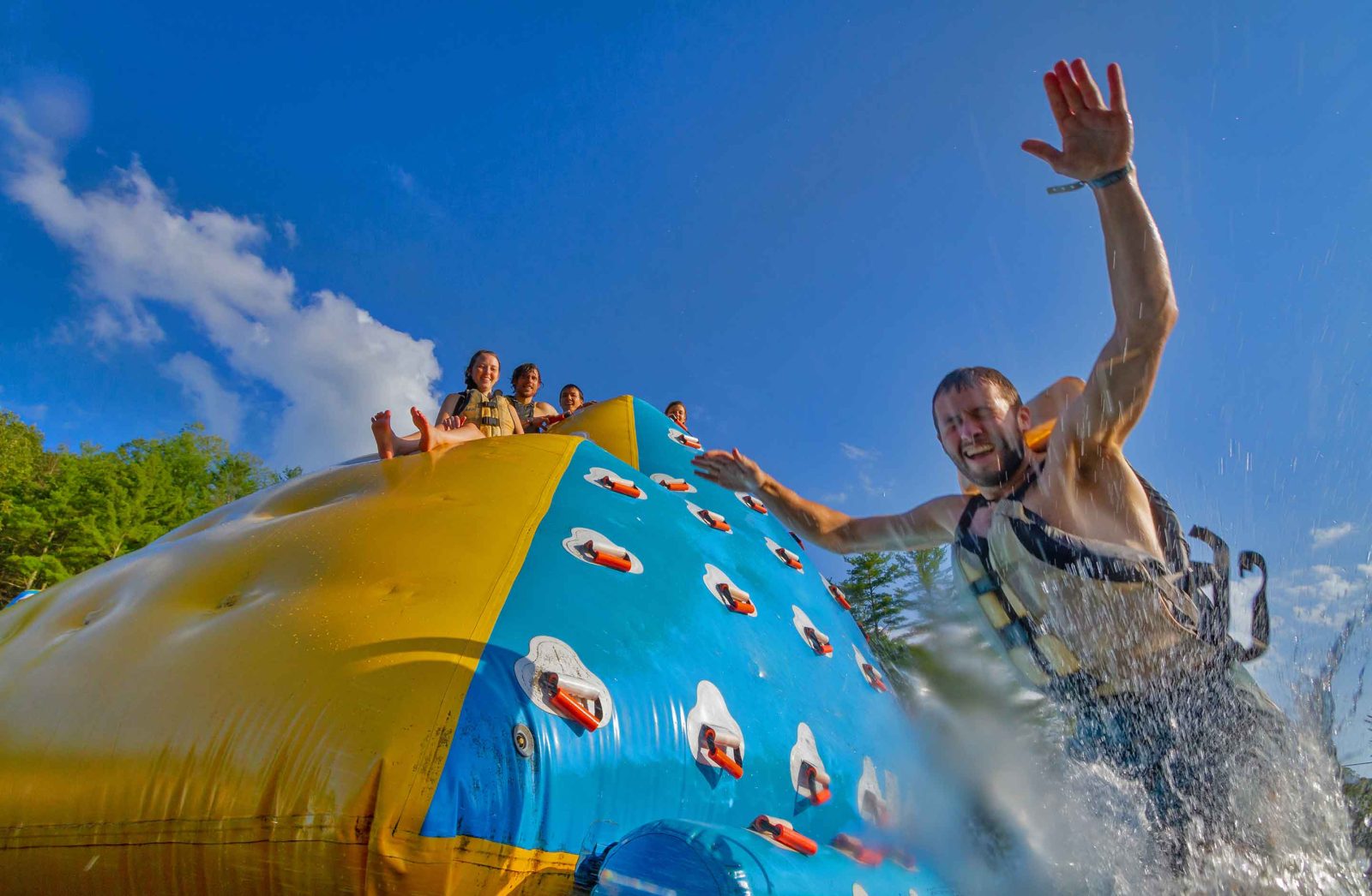 A young man leaps from a floating pyramid at ACE Adventure Resorts West Virginia Water Park.