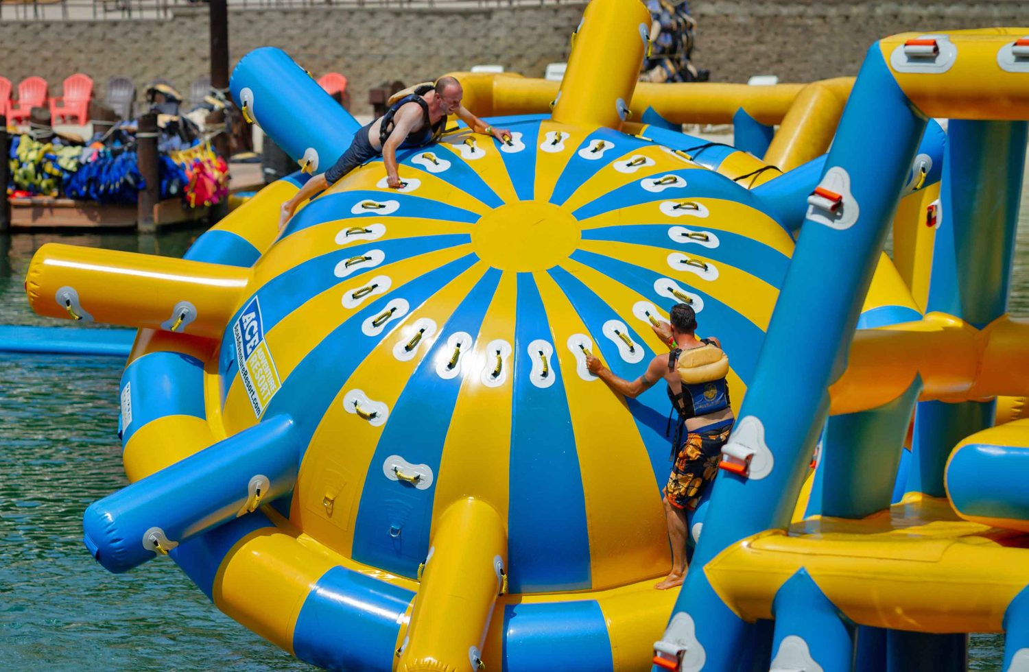 A couple teens play on the giant floating saturn balls at ACE Adventure Resorts West Virginia Water Park.