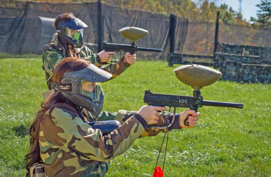 Two women target practice test their paintball guns on the walk on course at ACE Adventure Resort.