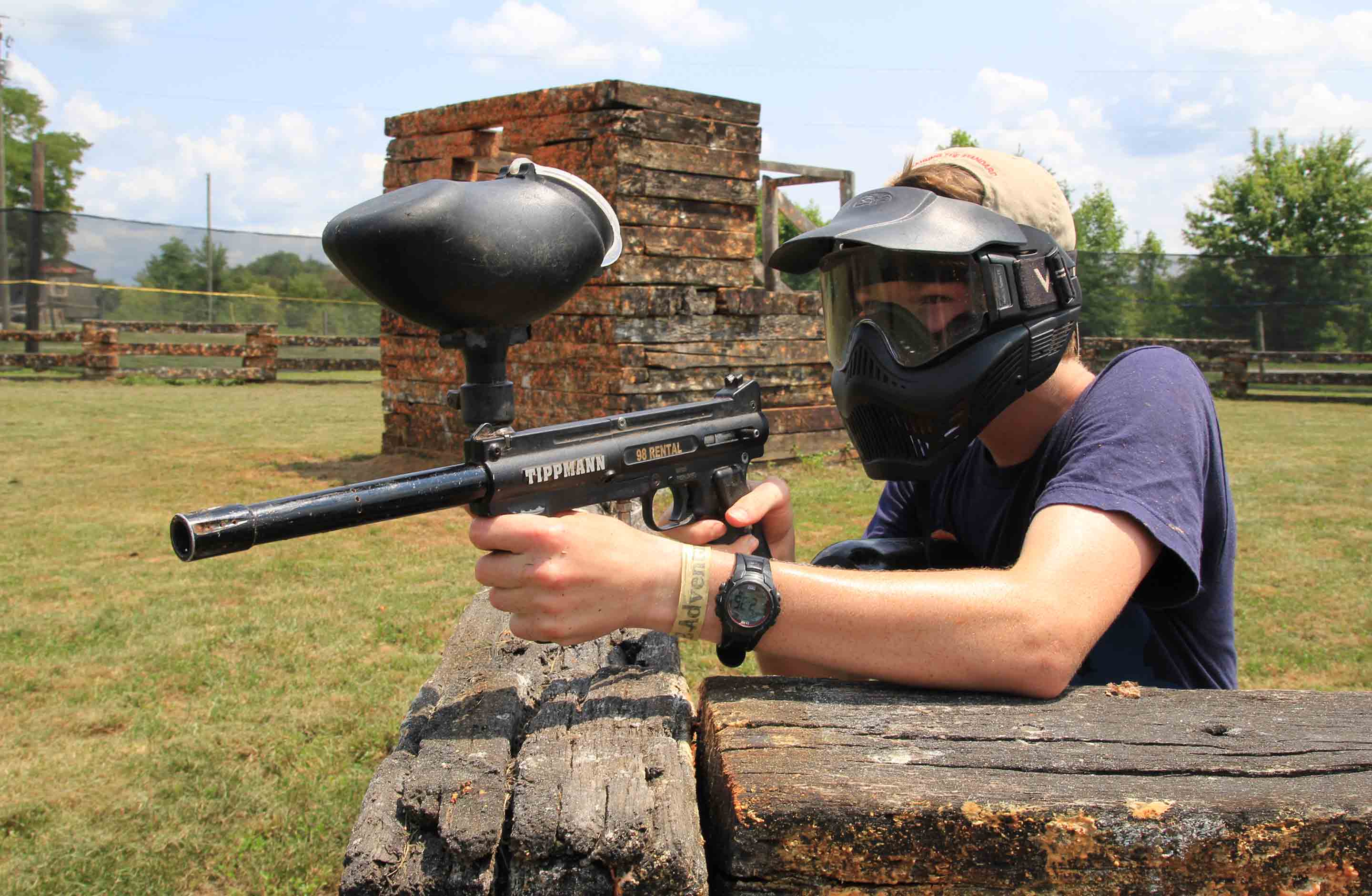 An older kid aims his paintball gun on the mountaintop course at ACE Adventure Resort.