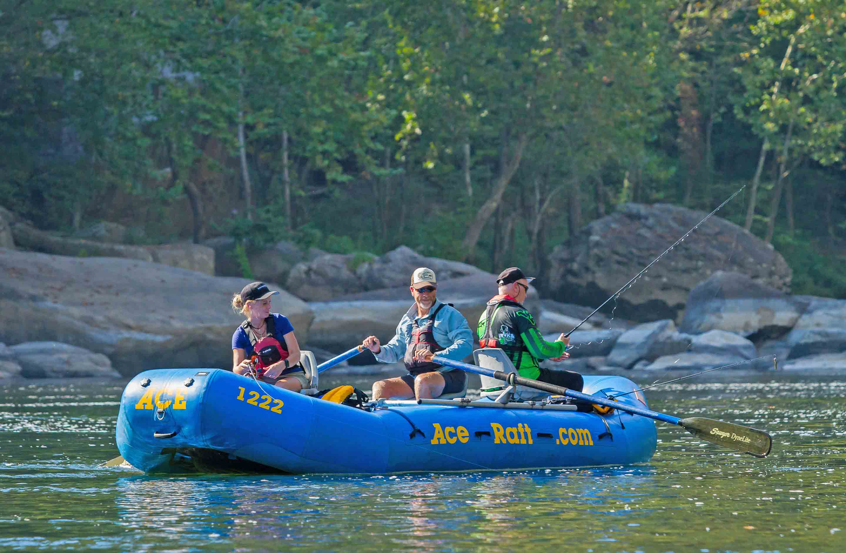 A group fishes from a raft on the Lower New River on a guided fishing tour with ACE Adventure Resort