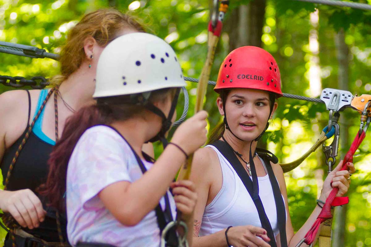 Two girls get ready to begin the zip lining tour at ACE Adventure Resort in the New River Gorge National Park.