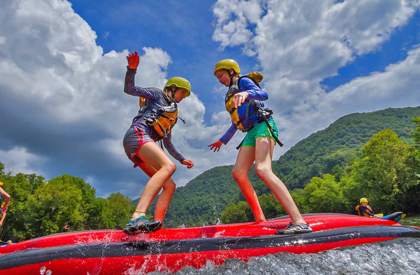 Two young girls play on the upper new river a popular west virginia whitewater rafting kids raft free rafting trip.