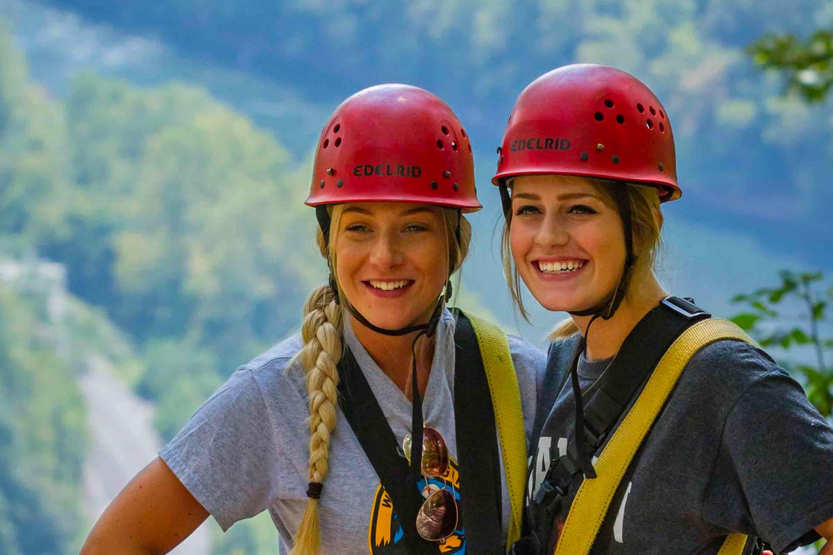 Girls smiling at the only new river gorge zipline tour with Gorge views.