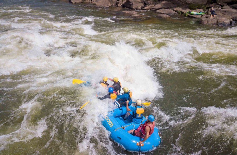 ACE guests paddle their raft through rapids on the Lower New River.