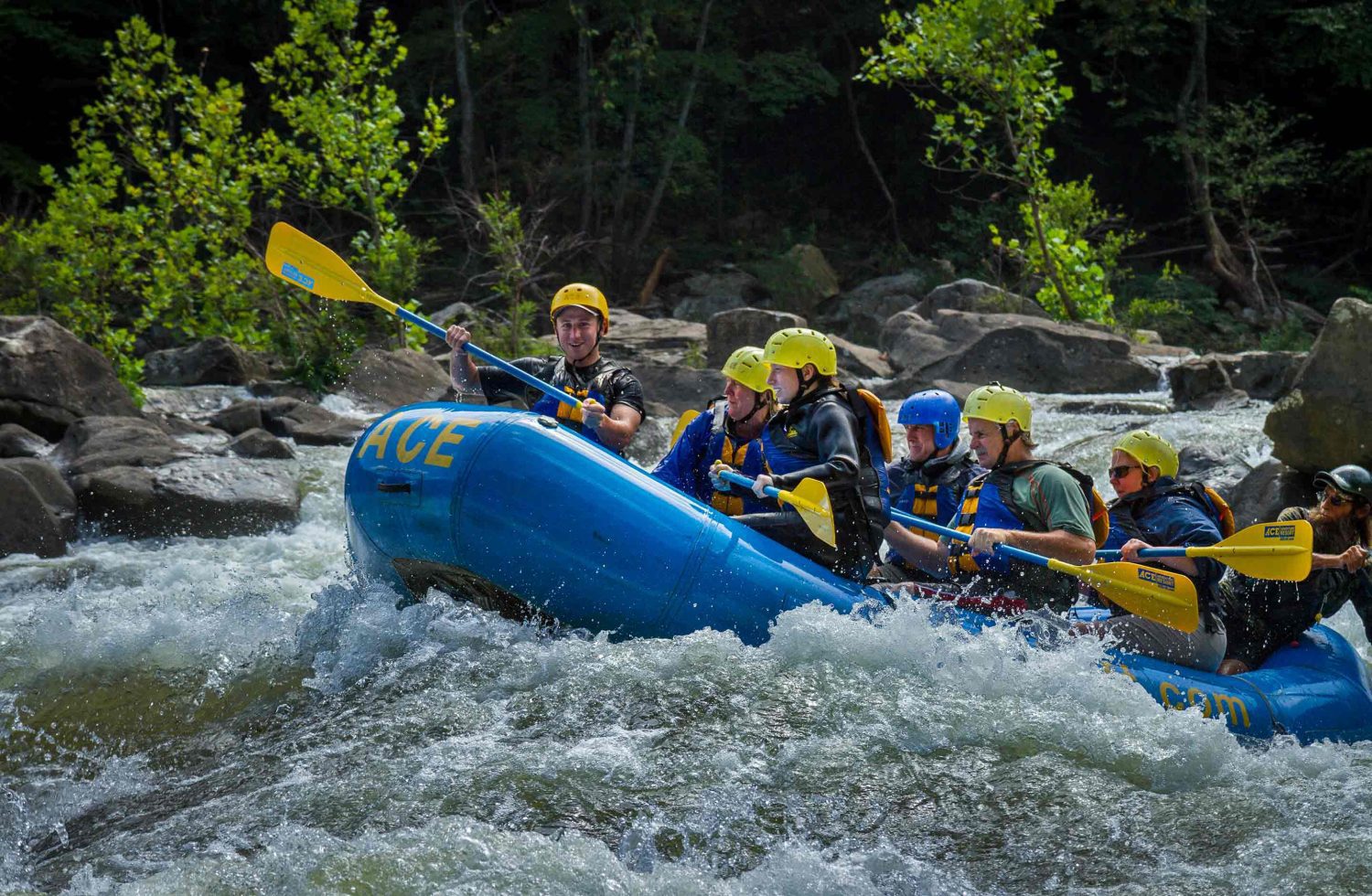 An ACE Adventure Resort raft crests a wave on a Lower Gauley rafting trip in West Virginia.