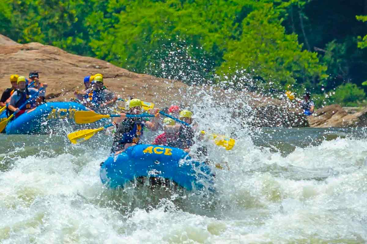 An ACE Adventure Resort raft hits a big wave head on in Middle Keeney rapid on a New River Gorge white water rafting trip in West Virginia.
