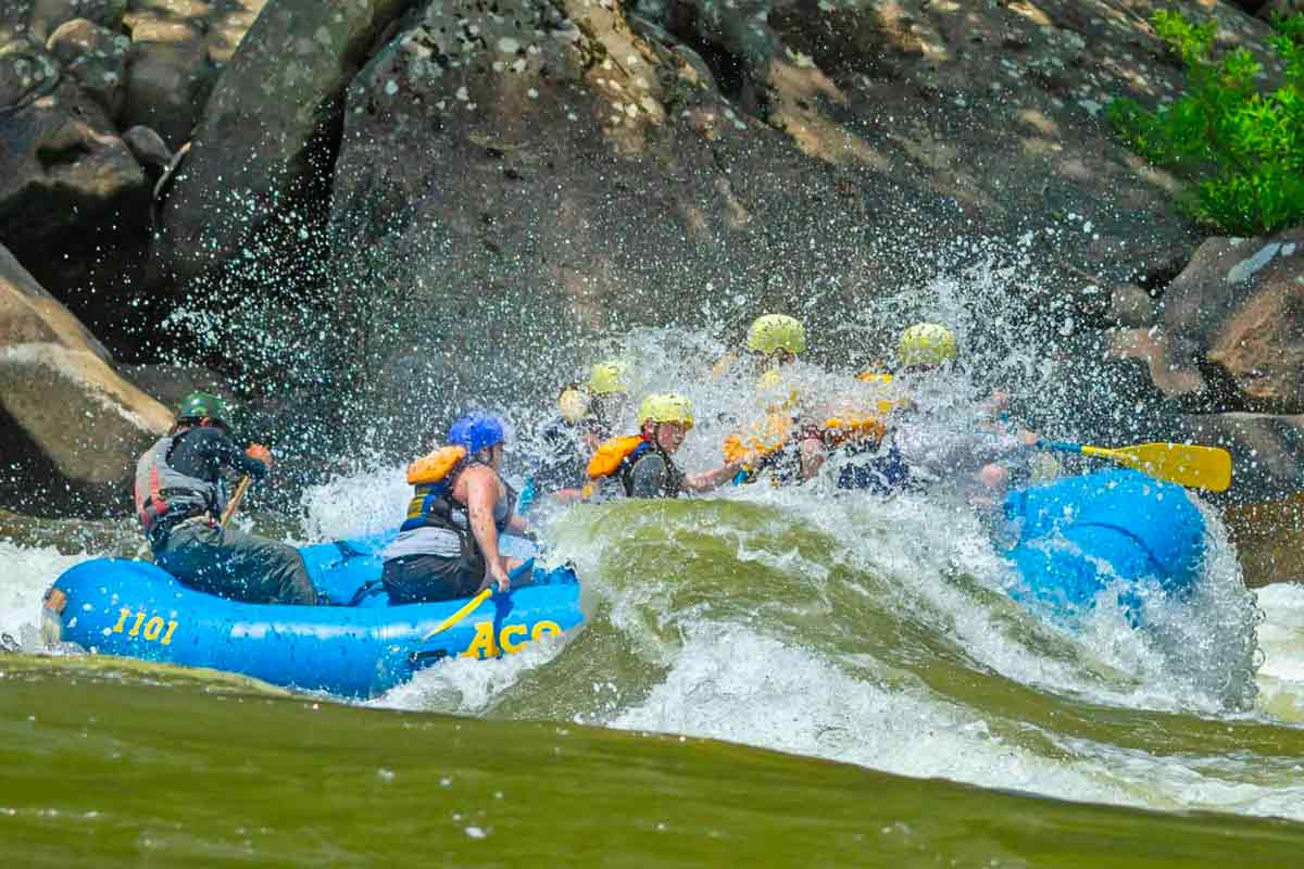 A giant wave buries a 16ft raft during a spring New River Gorge white water rafting trip in West Virginia.