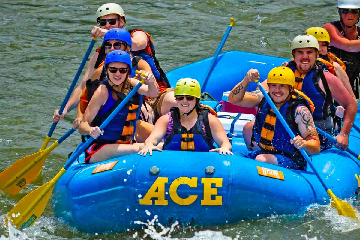 A woman smiles from the front of an ACE Adventure Resort raft during a New River Gorge white water rafting trip in West Virginia.