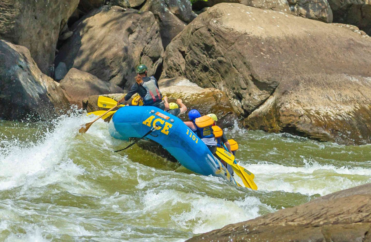 An ACE raft paddles out the bottom of Lower Keeney Rapid during a New River Gorge white water rafting trip in West Virginia.