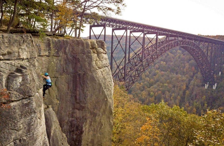 Climbing in the Lower New River Gorge with the New River Gorge Bridge in the background in West Virginia.
