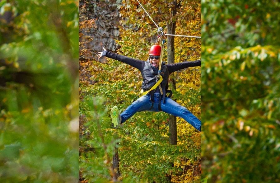 A woman strikes a pose on the zip line course at ACE Adventure Resort in West Virginia.