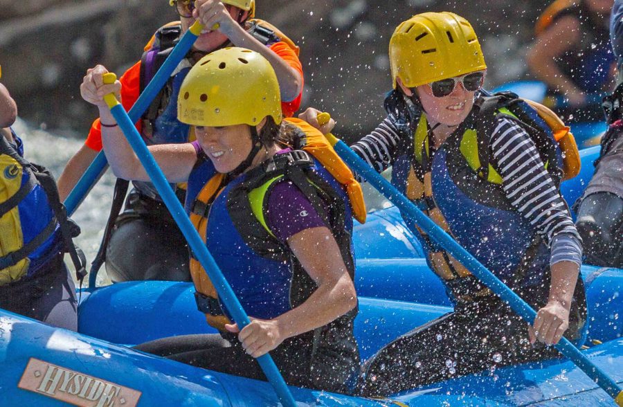 Girls paddle the Gauley River on a guided white water rafting trip with ACE Adventure Resort.