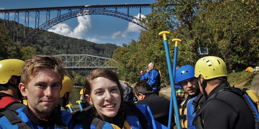 A couple on a Lower New River rafting trip poses under the New River Bridge on Bridge Day.