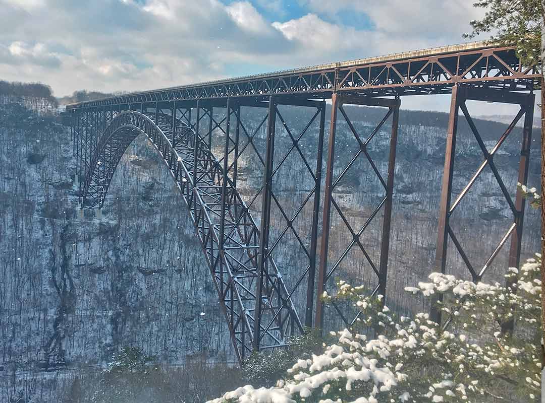 A view of the new river gorge winter featuring the snow covered bridge.