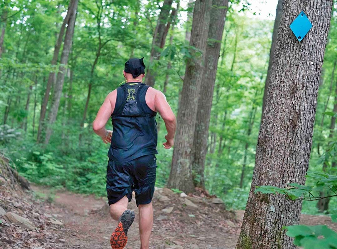 Man running through woods
