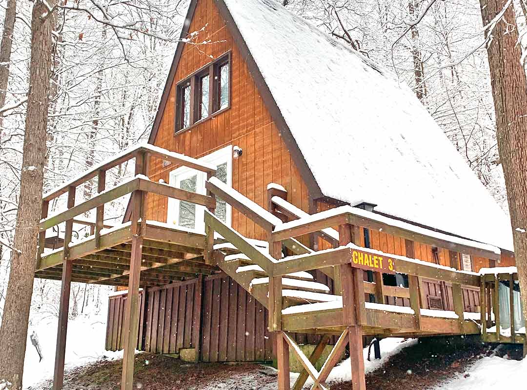 A view of one of ACE's classic chalets covered in snow during a New River Gorge winter in West Virginia.