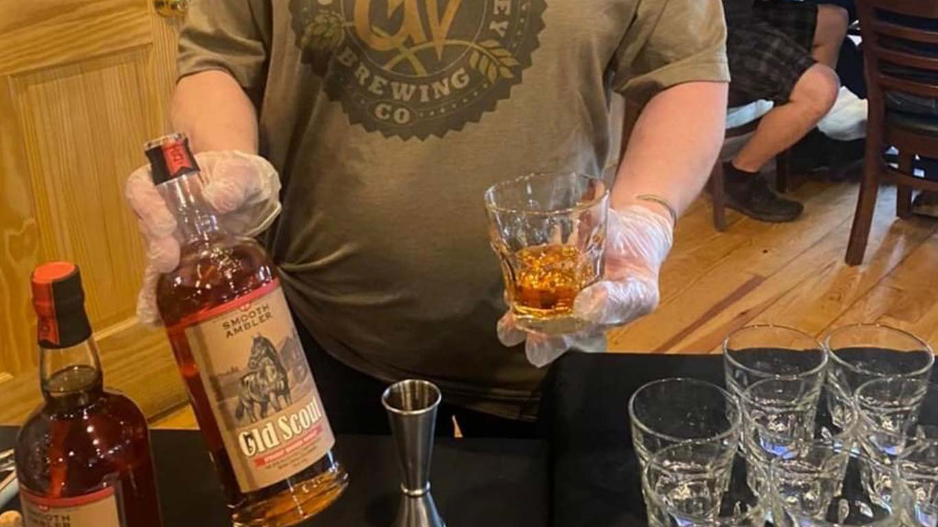 ACE employee serving bourbon at event