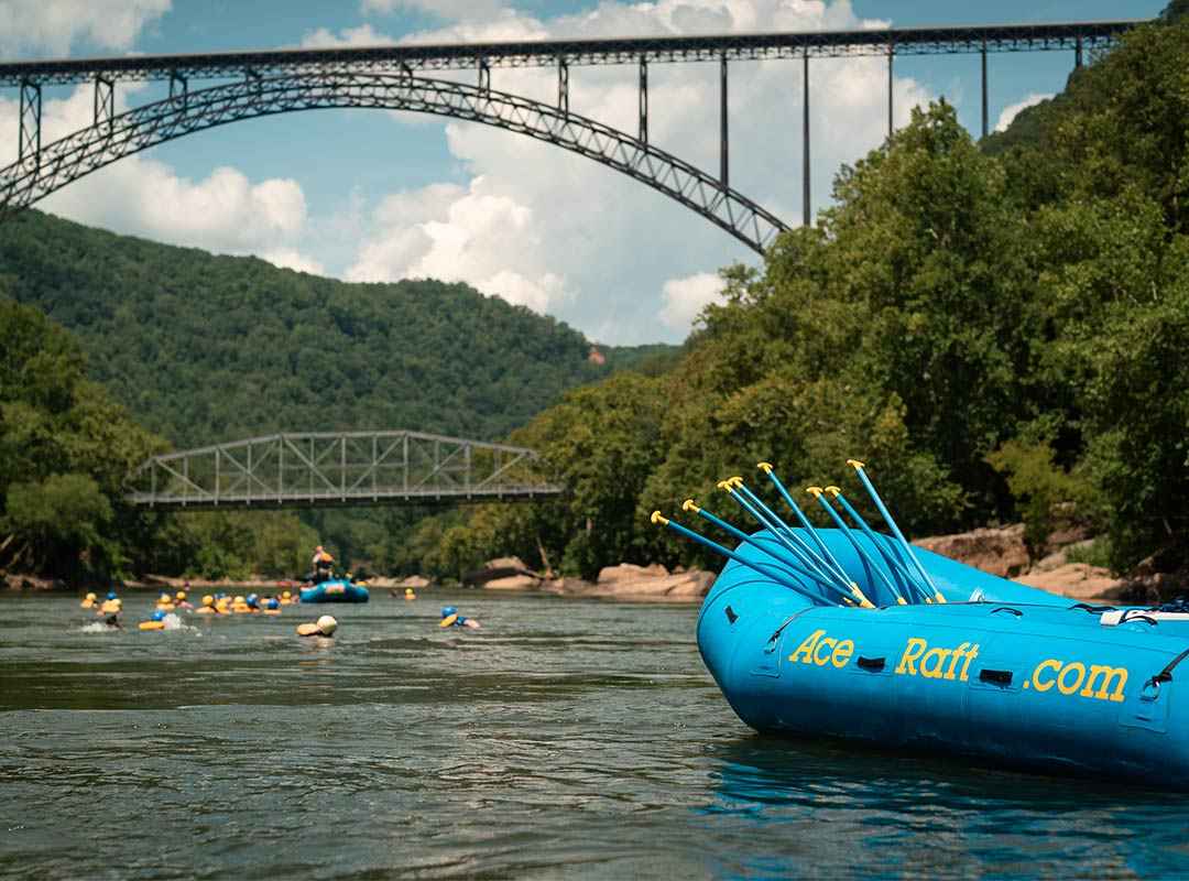 A scenic shot of the New River Gorge Bridge taken from a rafting trip in the New River Gorge National Park with ACE Adventure Resort.