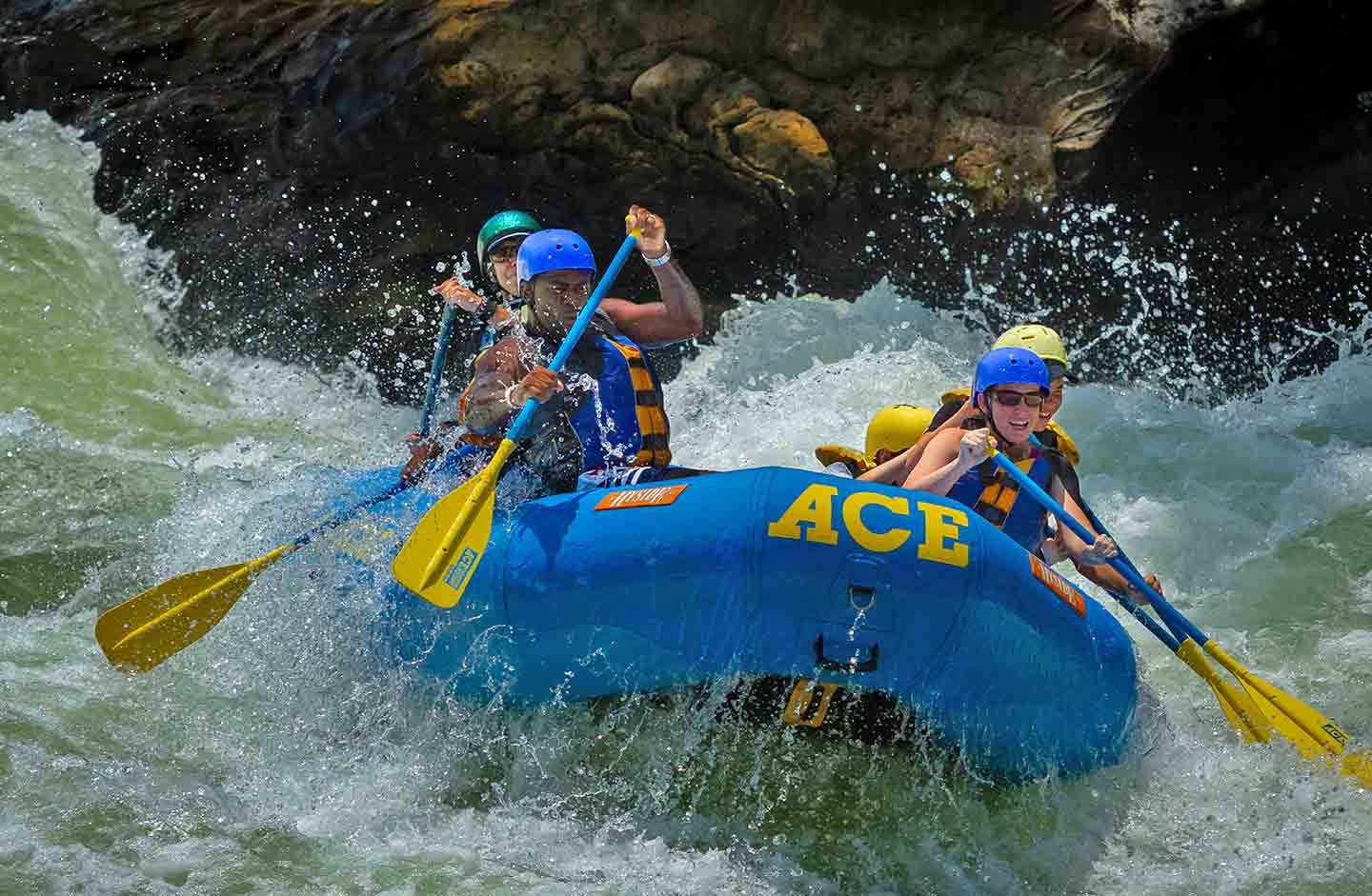 Guests raft through Lower Keeney Rapid in the New River Gorge National Park on an ACE Adventure Resort whitewater rafting trip.