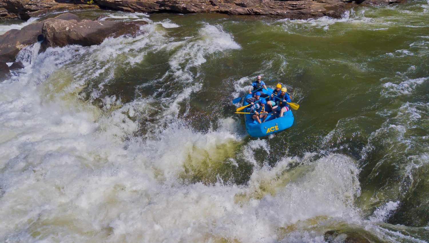 A raft drops over the 14' waterfall called Sweet's Falls on the Upper Gauley River in West Virginia.
