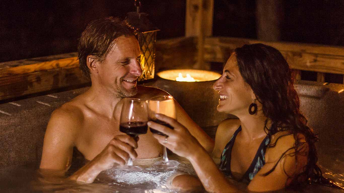 Couple in hot tub at ACE cabin