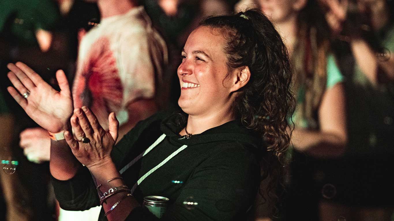 Guest in the crowd clapping to music