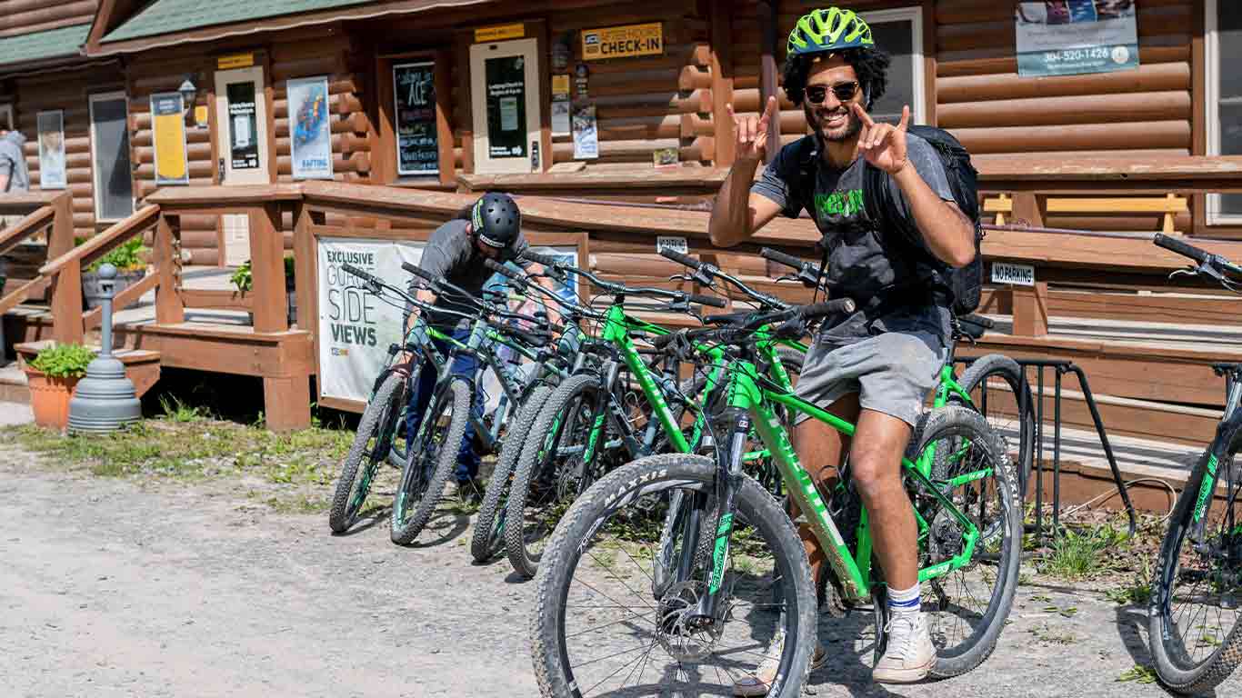 Guest posing on a bike in front of the Welcome Center