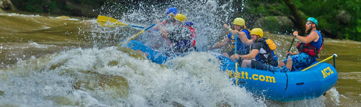 Rafters blast through a wave on the Lower New in the New River Gorge National Park with ACE Adventure Resort.